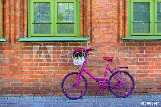 Picture of Pink bike standing by the wall